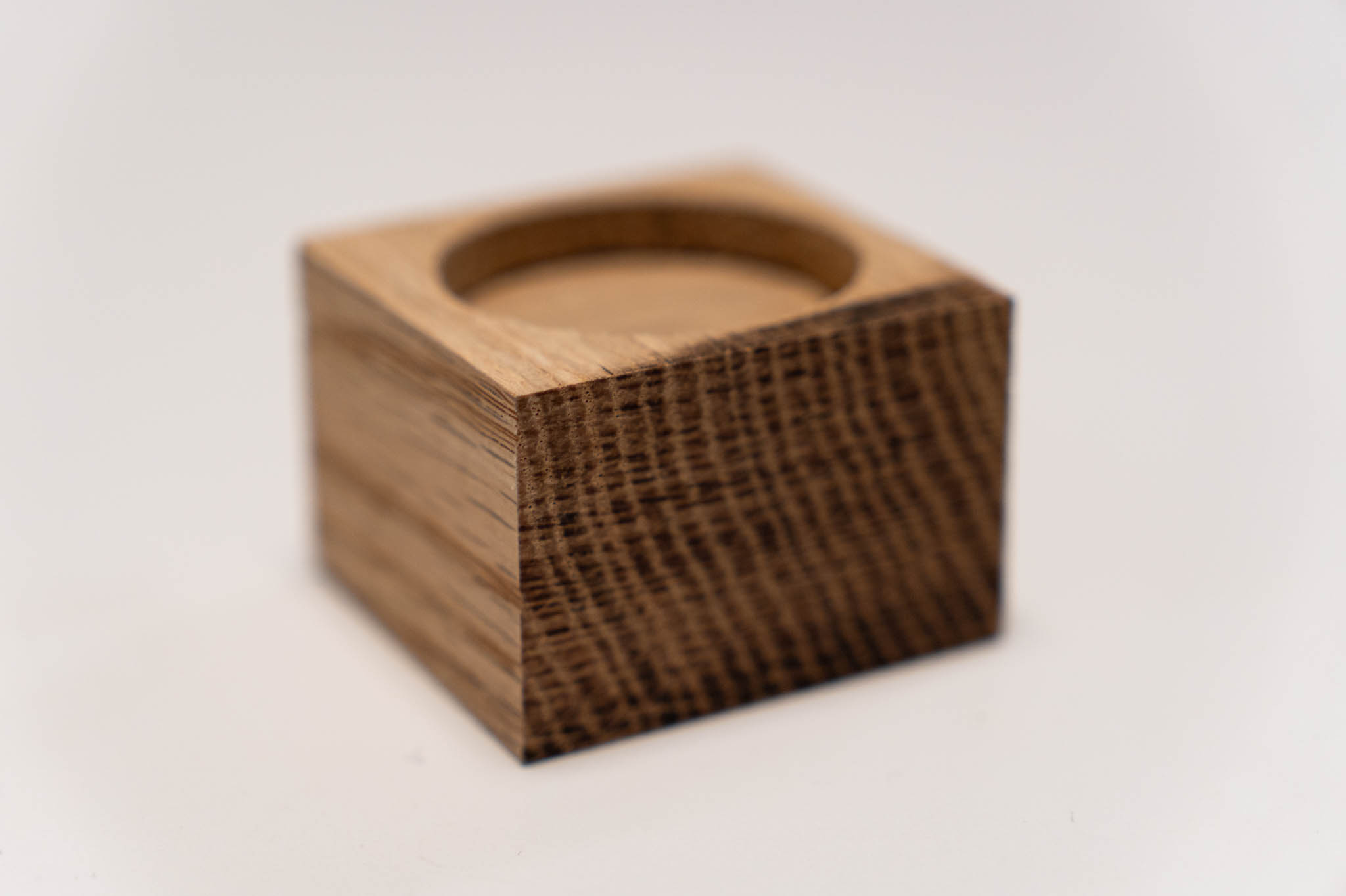 the back side of a small rectangular wooden light-brown box with its lid fully inserted